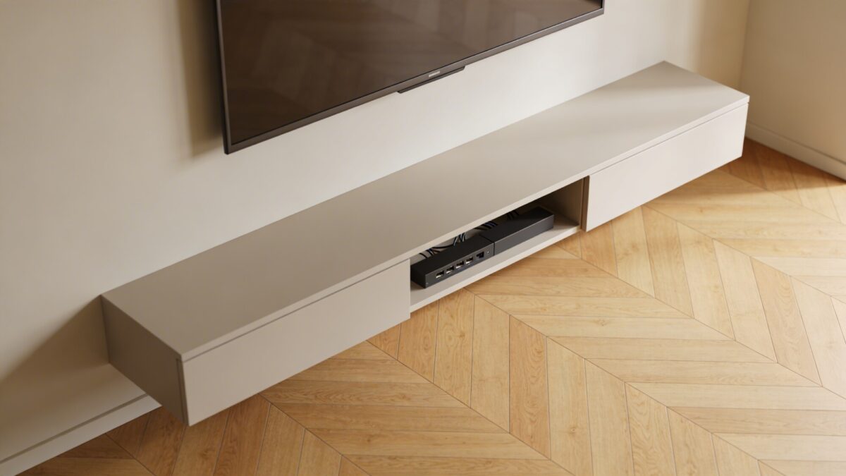 A living room viewed from above at an angle: a slim, low-profile TV mount, a floating console with hidden cables, and a light wood floor contrasted with a soft wall color that minimizes visual bulk.